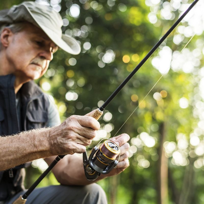 Fisherman with sun protection and hat