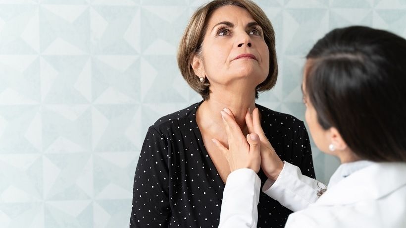 Woman having thyroid examined by an endocrinologist